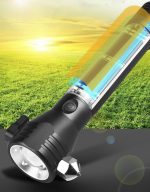 A black flashlight with a transparent power bank section, set against a grassy background and bright sky. It features a logo.