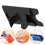A black silicone phone stand and smart wallet card holder featuring a curved back and an orange attachment.