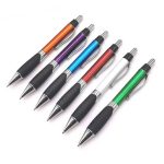 A set of plastic pens in orange, purple, blue, red, black, and green with rubber grips and silver accents.