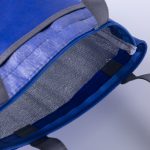 A blue lunch cooler tote with an insulated silver interior and grey handles, featuring a zip closure.