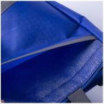A blue lunch cooler tote with a grey lining and an open zipper revealing the interior compartment.