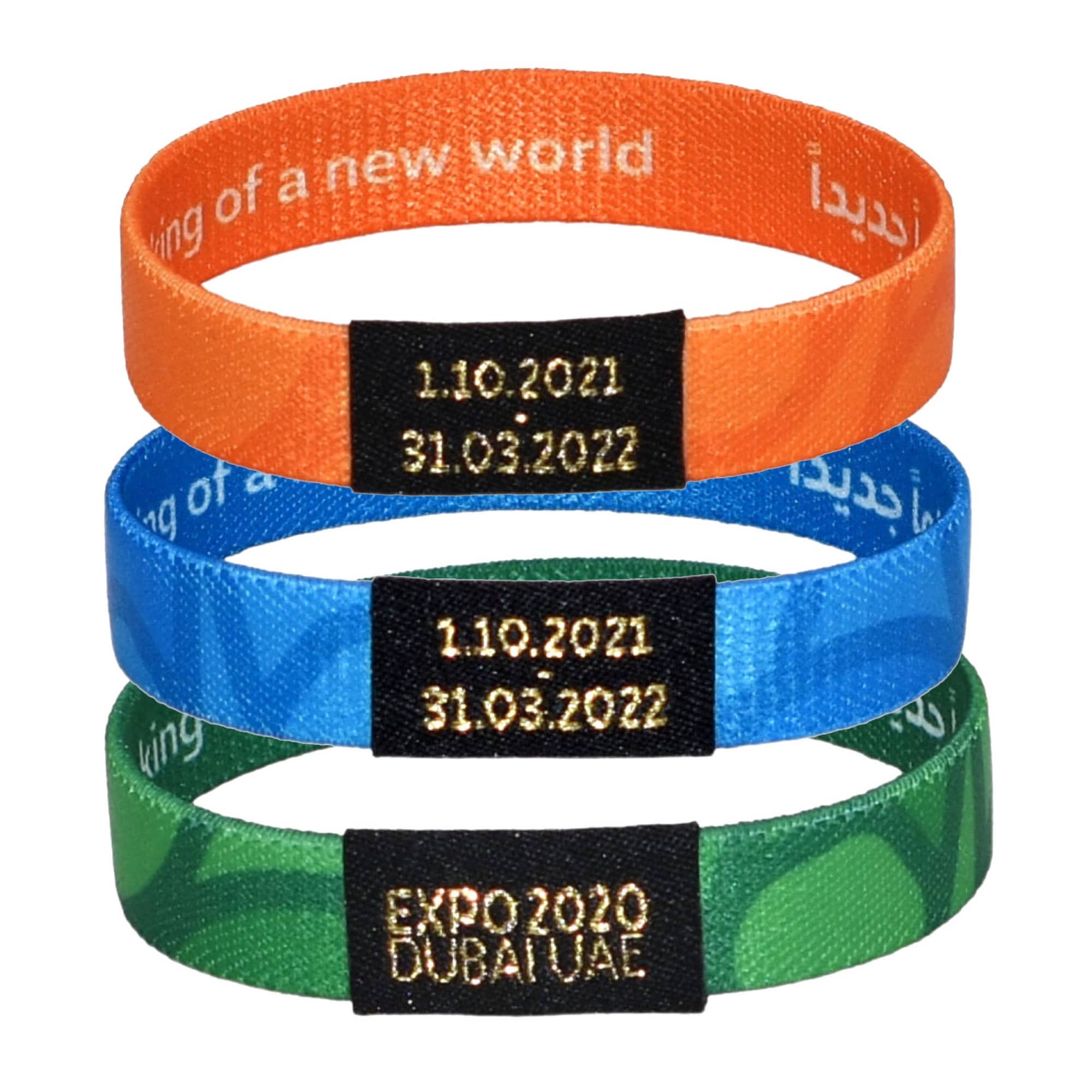 Three elastic wristbands in orange, blue, and green, each featuring a black logo and dates embossed on a label. Three elastic wristbands in orange, blue, and green, each featuring a black logo and dates embossed on a label.