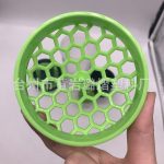 A green fitness shaker cup with a honeycomb design for efficient mixing, featuring a logo on its surface.