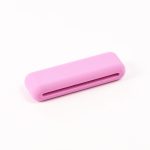 A pink silicone weighted bracelet with a smooth surface and a slot running through the centre.