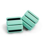 A pair of silicone weighted bracelets in a teal colour with ridged designs. The image includes a logo.