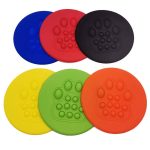 A set of pet flying discs in blue, red, yellow, green, black, and orange, each featuring a paw print design.