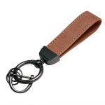 A brown suede car keychain with a black metal ring and attachment, featuring a stylish loop design.