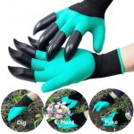 Clawed garden gloves in turquoise with black claw-like tips, displayed on hands in a gardening setting.