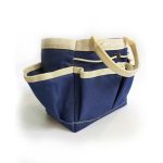 A navy blue garden tote with cream handles and pockets for storage, featuring a sturdy design.