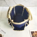 A navy blue garden tote with a cream-coloured top edge and handles, featuring an open interior and no visible contents.