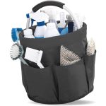 A portable black tool basket filled with cleaning supplies, including bottles, scrub brushes, and sponges.