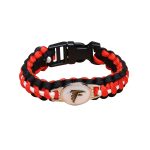 A flag pattern paracord bracelet in red, black, and white, featuring a logo and a whistle attachment.