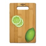 A bamboo cutting board with a handle cutout, featuring lime slices and a whole lime, and displaying a logo.