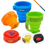 A set of foldable silicone travel cups in blue, green, orange, and red, featuring various logos.