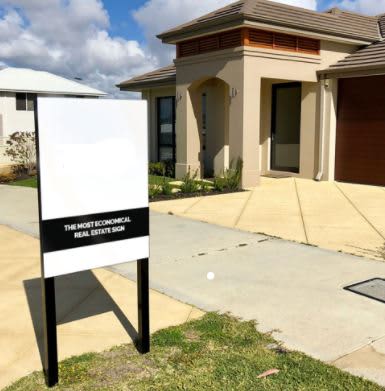 A flat metal sign in white and black, placed outside a beige house with a modern design. Flat Metal Signs 600mm X 900mm-Total Height 1500mm - Image 1