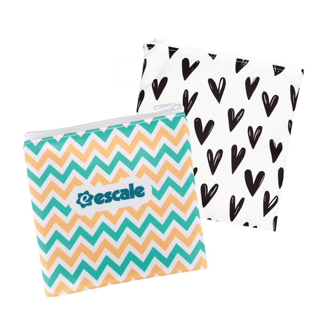 A set of two reusable food pouches featuring a turquoise and orange chevron pattern and a black heart design, both with zippers. Reusable Food Pouch with Zipper Closure - Image 1