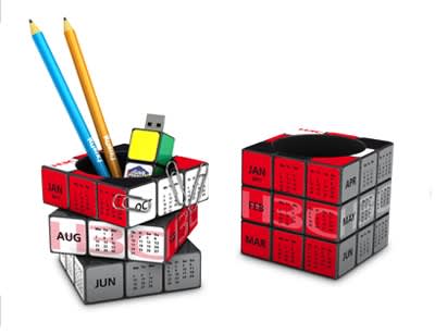 A Rubik's-style pen pot in red, white, and black, featuring cubed compartments for stationery items. Rubik's Pen Pot - Image 1