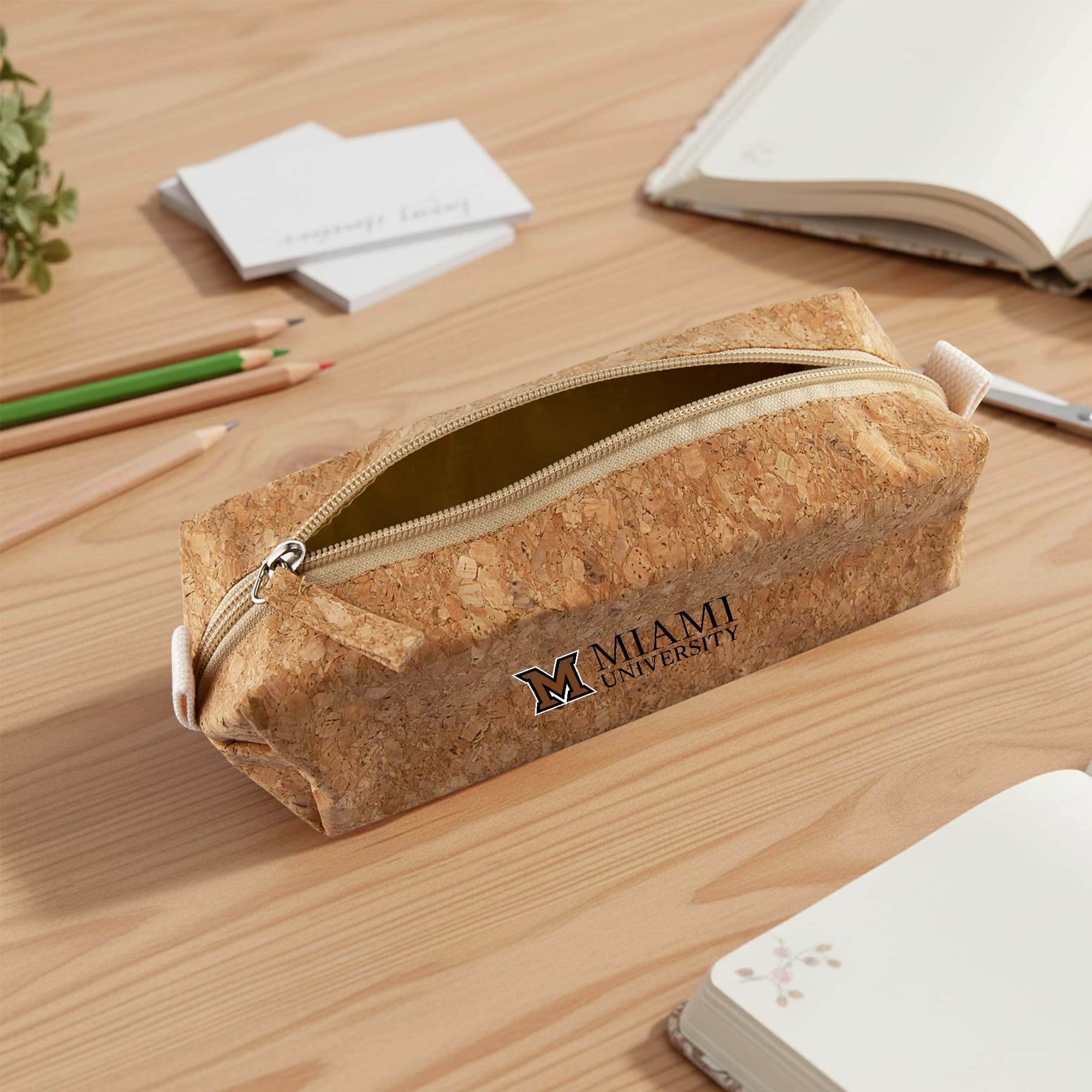 A cork pencil case in a rectangular shape with a zip closure, featuring a logo and a natural cork colour. Cork Pencil Case - Image 1