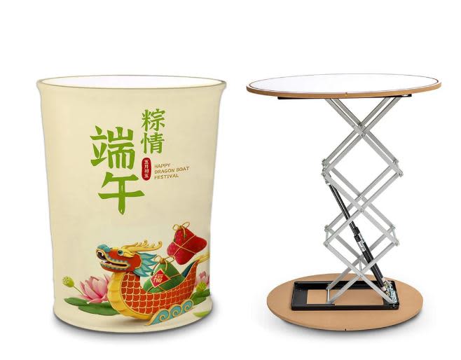 A promotional hydraulic table in a round shape, featuring a white top and a colourful, festive design on the base. Stretch Fabric Hydraulic Promotion Table 700 x 400 x 1000mm - Image 1