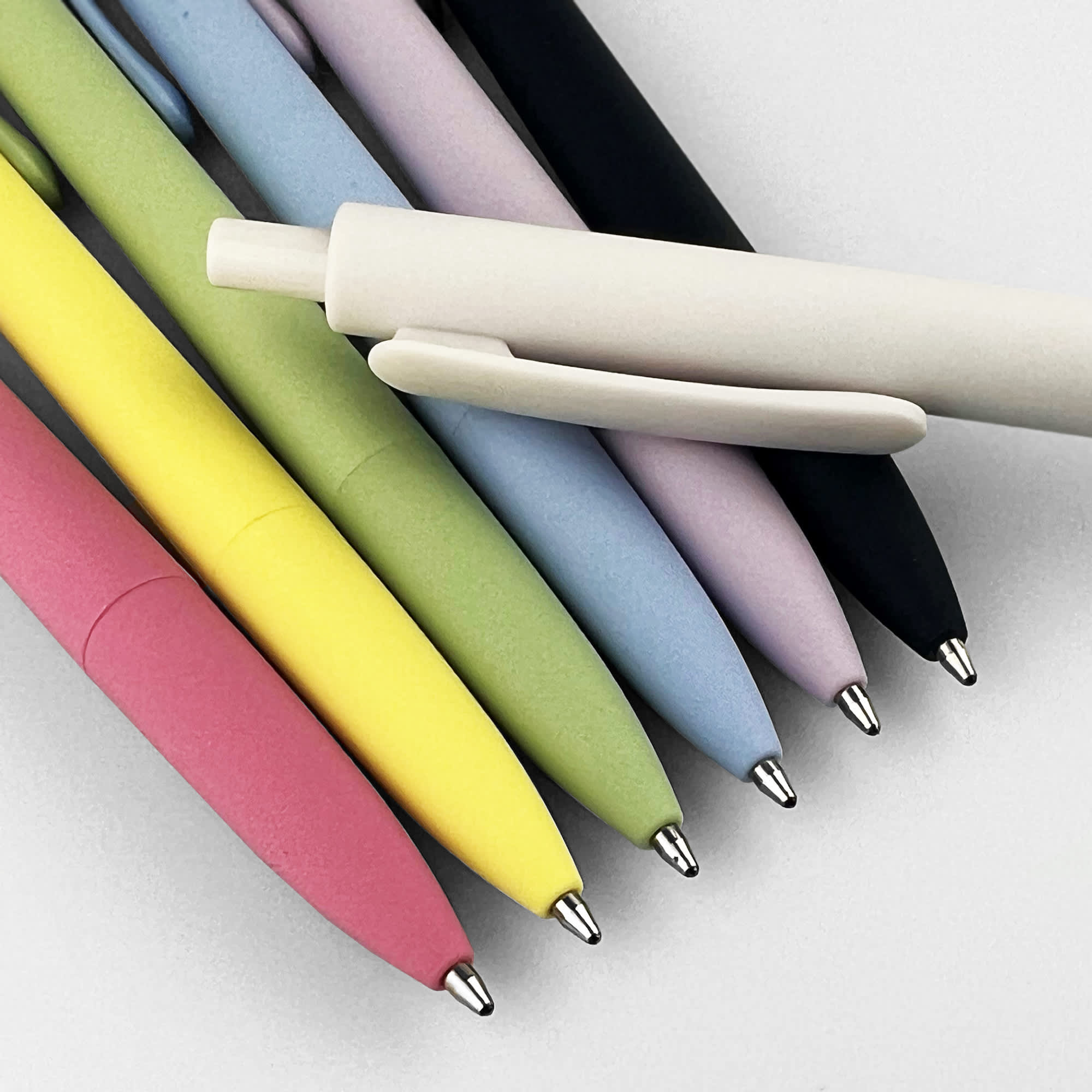 A collection of plastic pens in various colours, including pink, yellow, green, blue, lilac, black, and white, with a logo. Smooth - Image 1