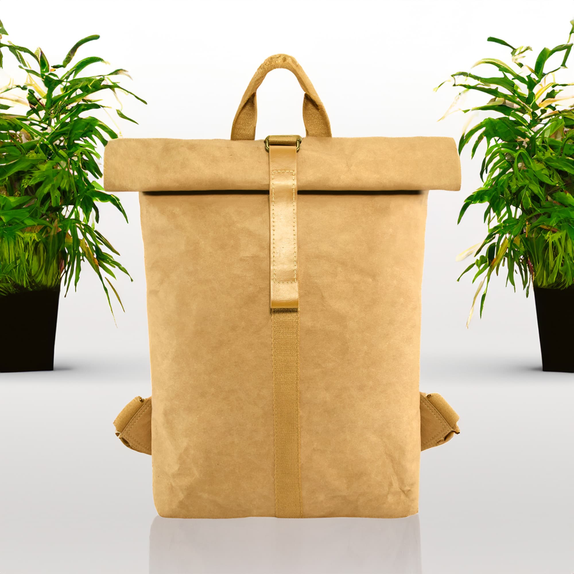 A tan kraft paper backpack with a roll-top closure and adjustable straps, surrounded by potted plants. The Mate Kraft Paper Backpack - Image 1