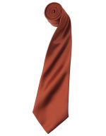 A satin tie rolled into a cylindrical shape, featuring a rich copper colour and a smooth finish.