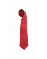 A red tie rolled neatly, featuring a simple design and a logo on the fabric.