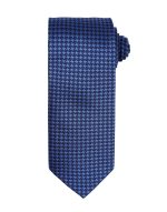 A blue tie featuring a houndstooth pattern, rolled neatly for display. It has branding on the label.