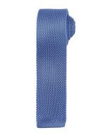 A slim knitted tie in a light blue shade with a textured finish. It features a logo on the label.