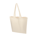 A beige calico tote bag with two handles, featuring a simple design and no visible branding.