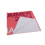 A pink sublimated beach towel featuring a reversible design, with a soft, white underside and a branding logo.