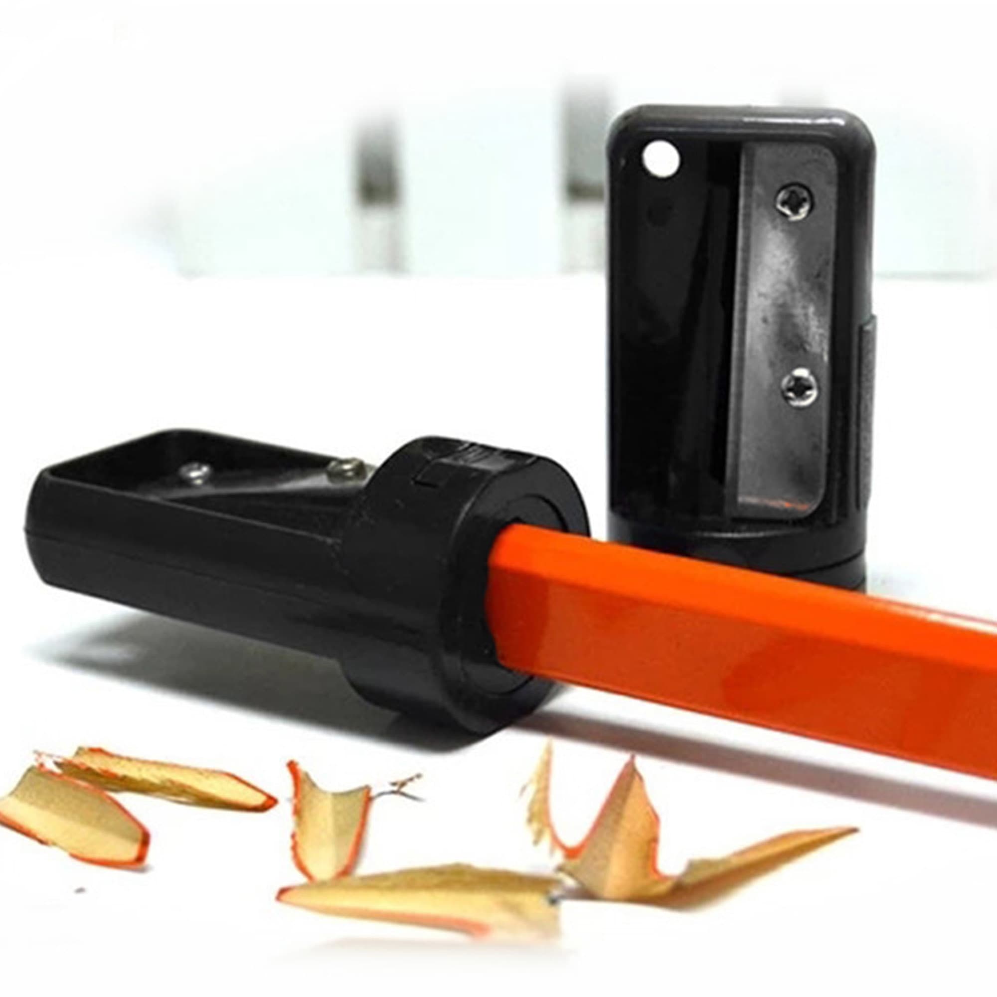 A carpenter pencil sharpener in black and orange, with wood shavings beside it. It features a logo on the casing. Carpenter Pencil Sharpener - Image 1