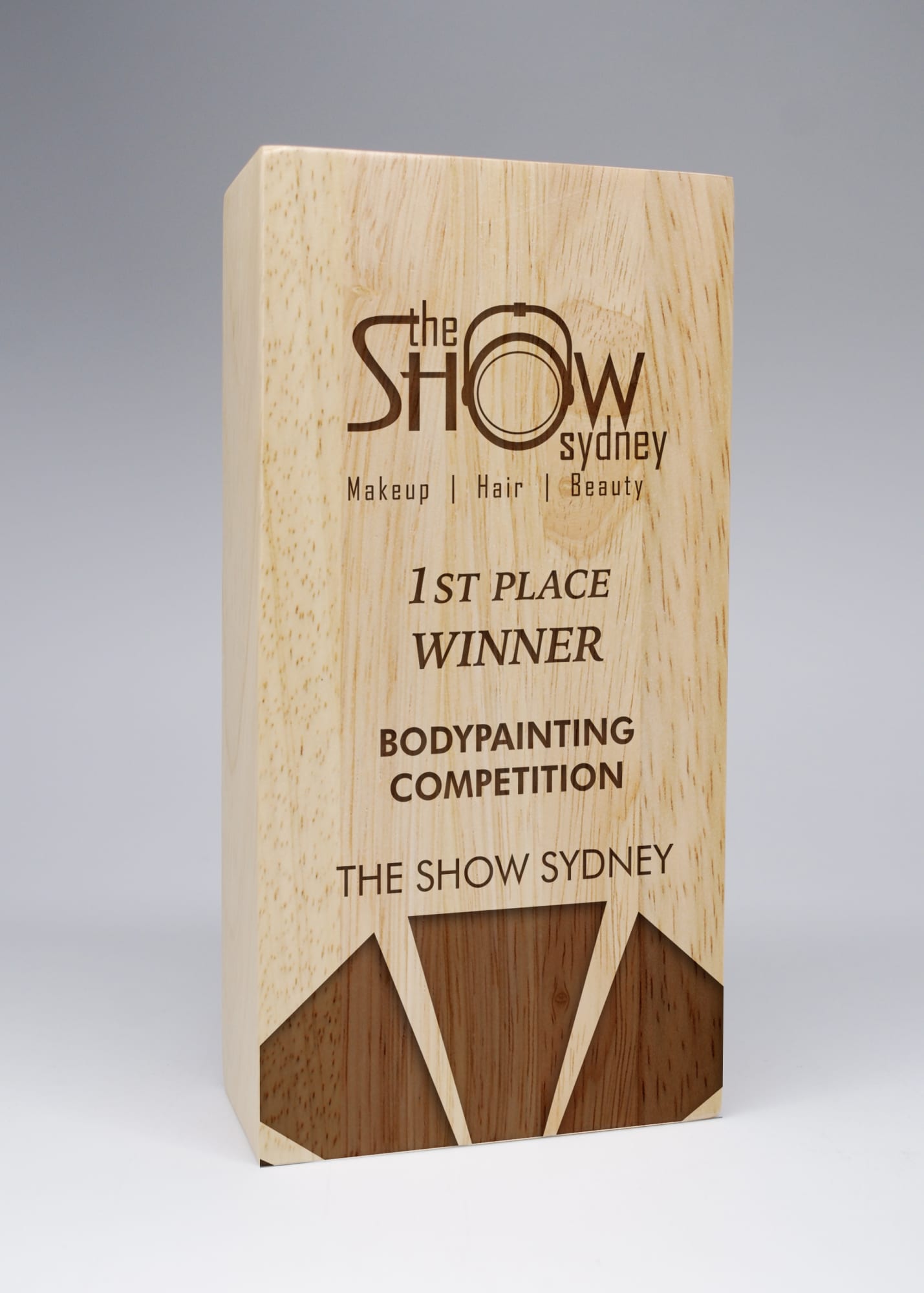 A wooden award in a light natural finish with angular design elements, featuring engraved text and a logo. Column Wood Award - Add Engraving Costs - Image 1