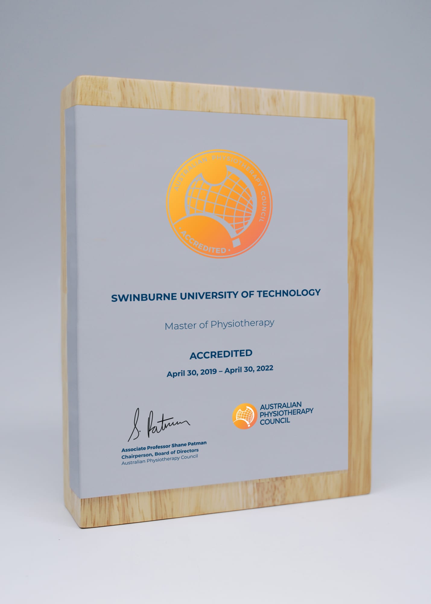 A wooden block award featuring a printed metal plate, showcasing an accreditation with a logo. Wood Block Award with Printed Metal Plate - Image 1
