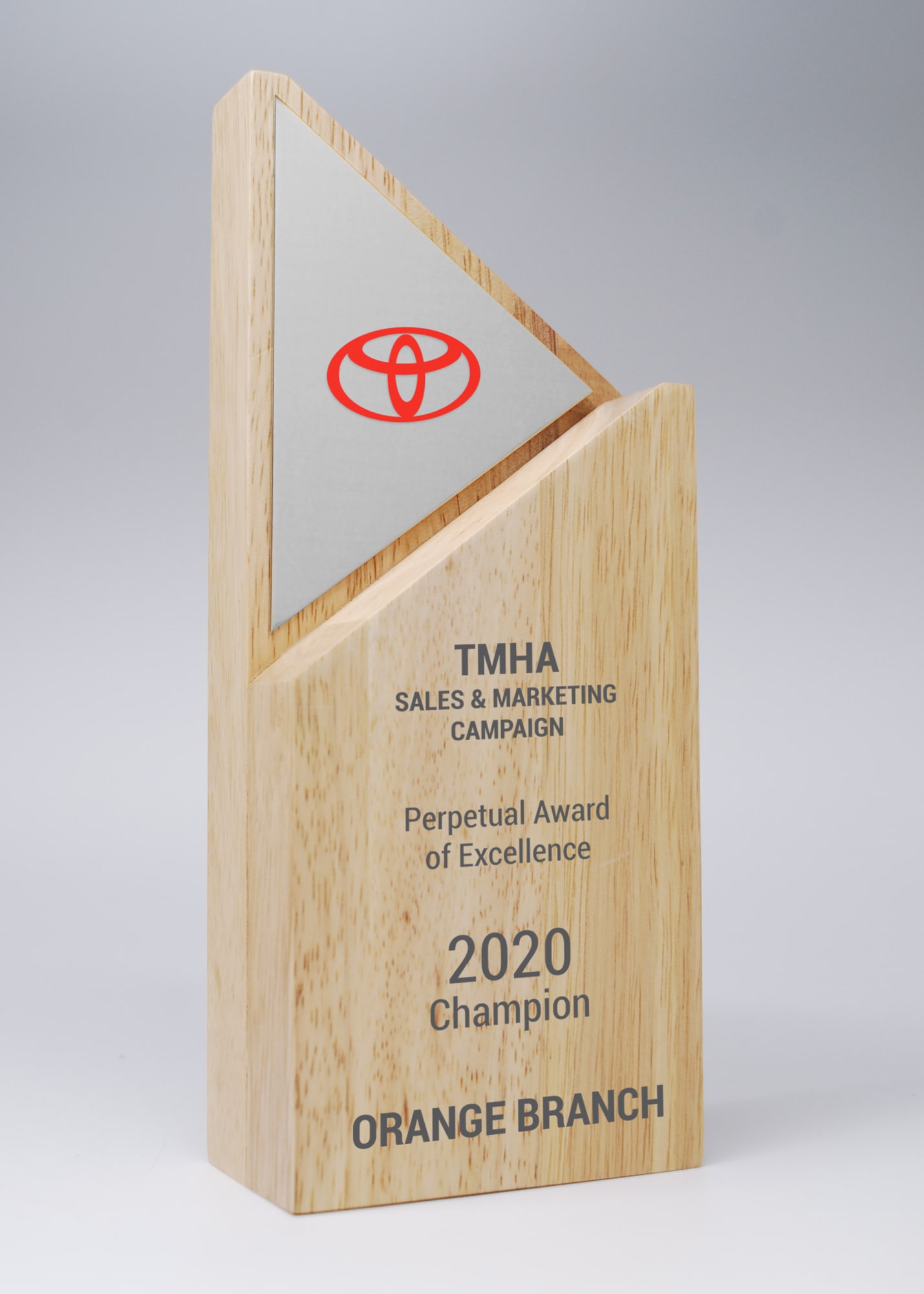 A wooden award with a triangular silver plate on top, featuring a logo and engraved text. Arrow Wood Award with Mirror Silver Printed Plate - Image 1