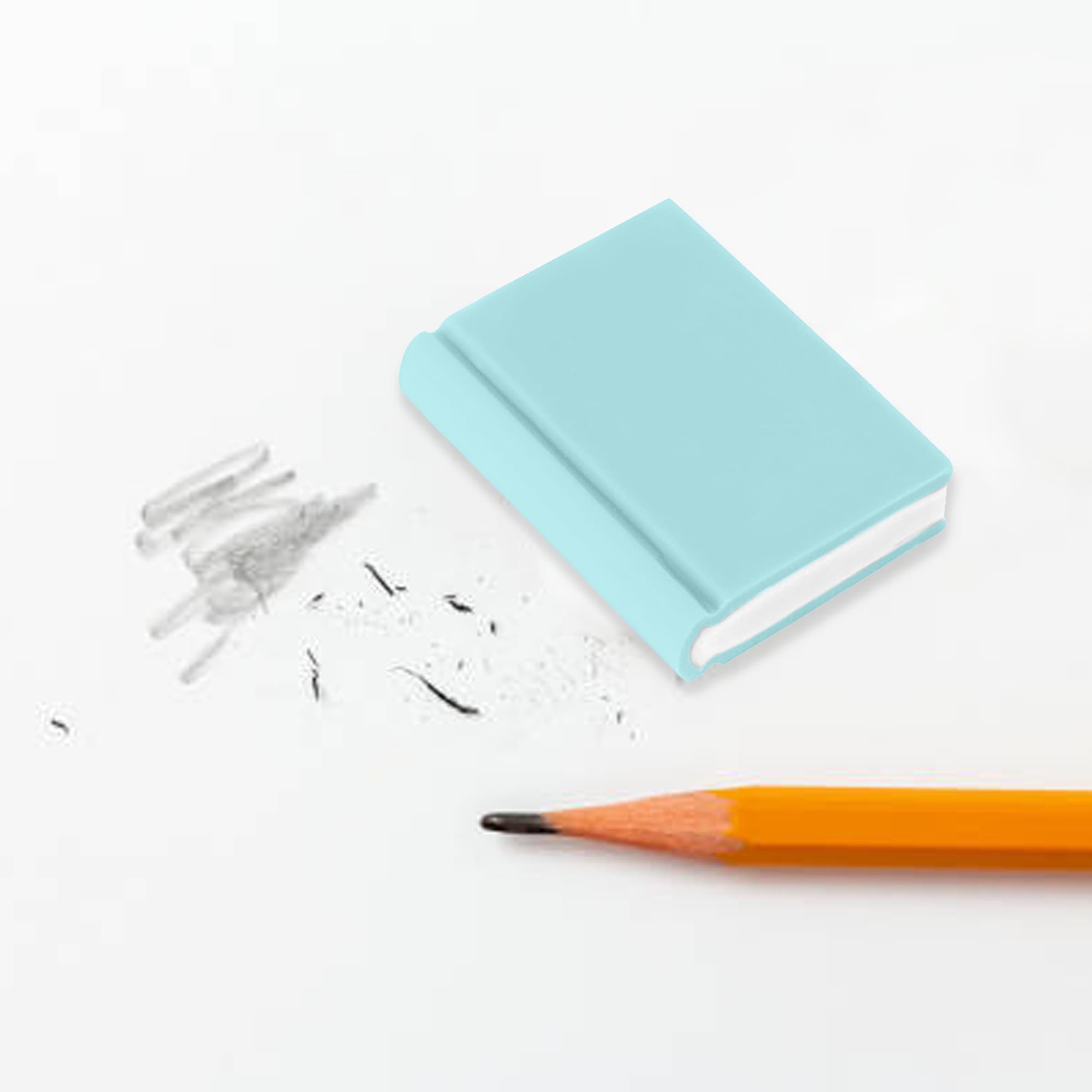 A light blue book-shaped rubber eraser beside pencil marks and a sharpened orange pencil on a white surface. Book Shaped Rubber Eraser - Image 1