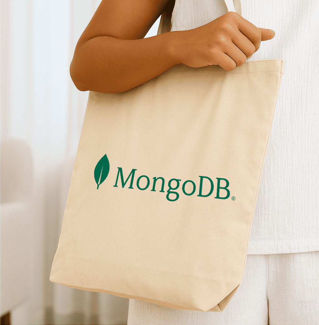 A natural beige tote bag with a logo on one side. The bag features sturdy handles for easy carrying. Willow Natural Tote - Image 1