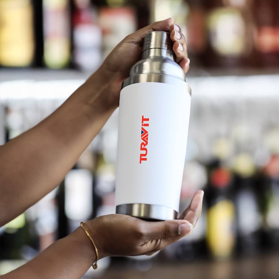 A drink bottle features a sleek white design with a stainless steel top and a logo. Ideal for beverages. Kennedy Shaker (600mL) - Image 1