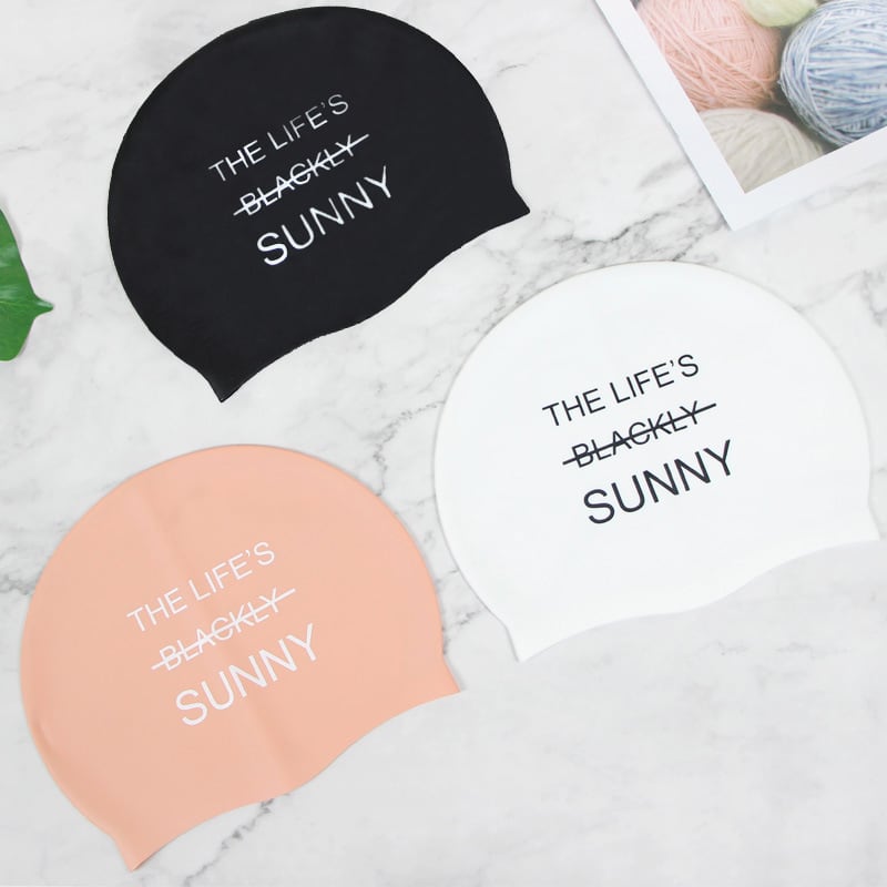 A set of three silicone swim caps in black, white, and peach, featuring a logo on each cap. Silicone Swim Cap ( child size ) - Image 1