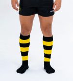 Custom knee-length socks in black and yellow stripes, with a logo visible on the design.