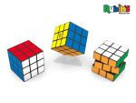 A Rubik's Cube 3x3 in red, white, blue, and yellow, displayed with multiple cubes on a stand. Branding is visible.