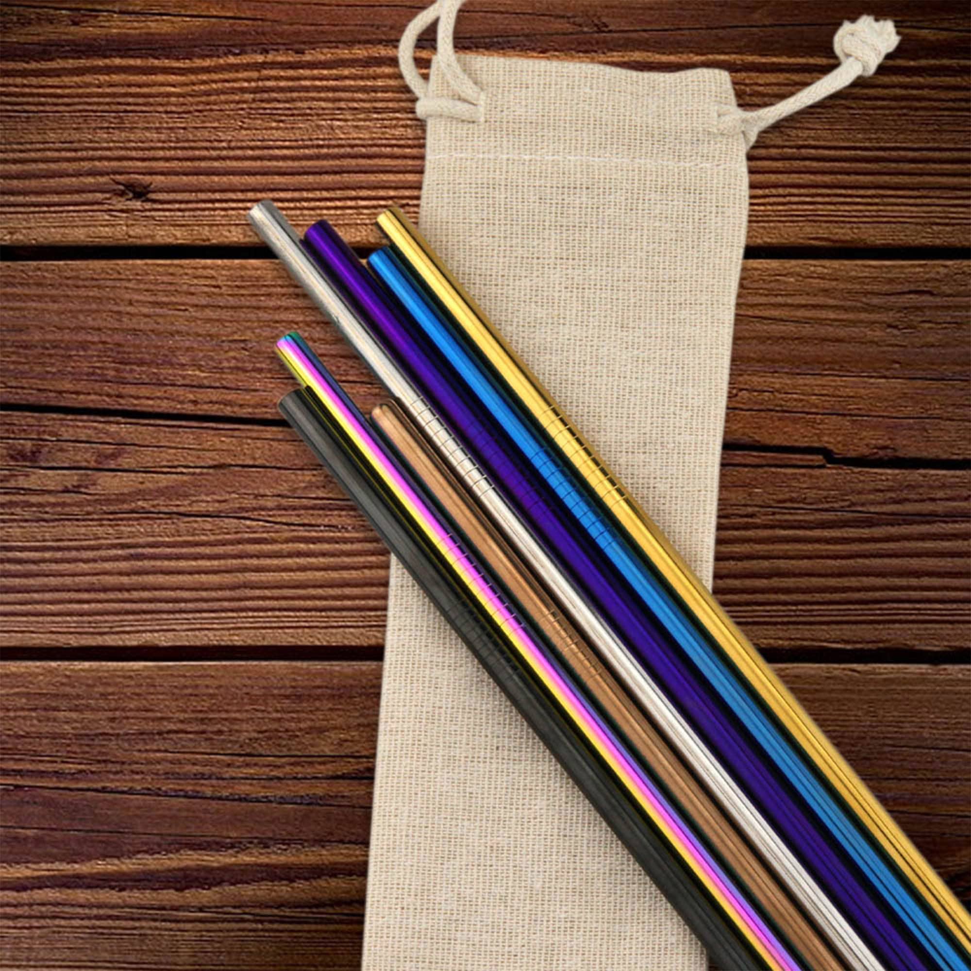 A collection of stainless steel drinking straws in various colours, resting on a canvas bag against a wooden background. Stainless Steel Straw 6mm x 215mm - Image 1
