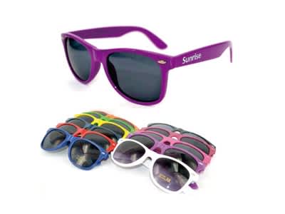 A pair of purple fashion sunglasses with dark lenses, surrounded by various colourful sunglasses in different styles. Fashion Sunglasses - Image 1