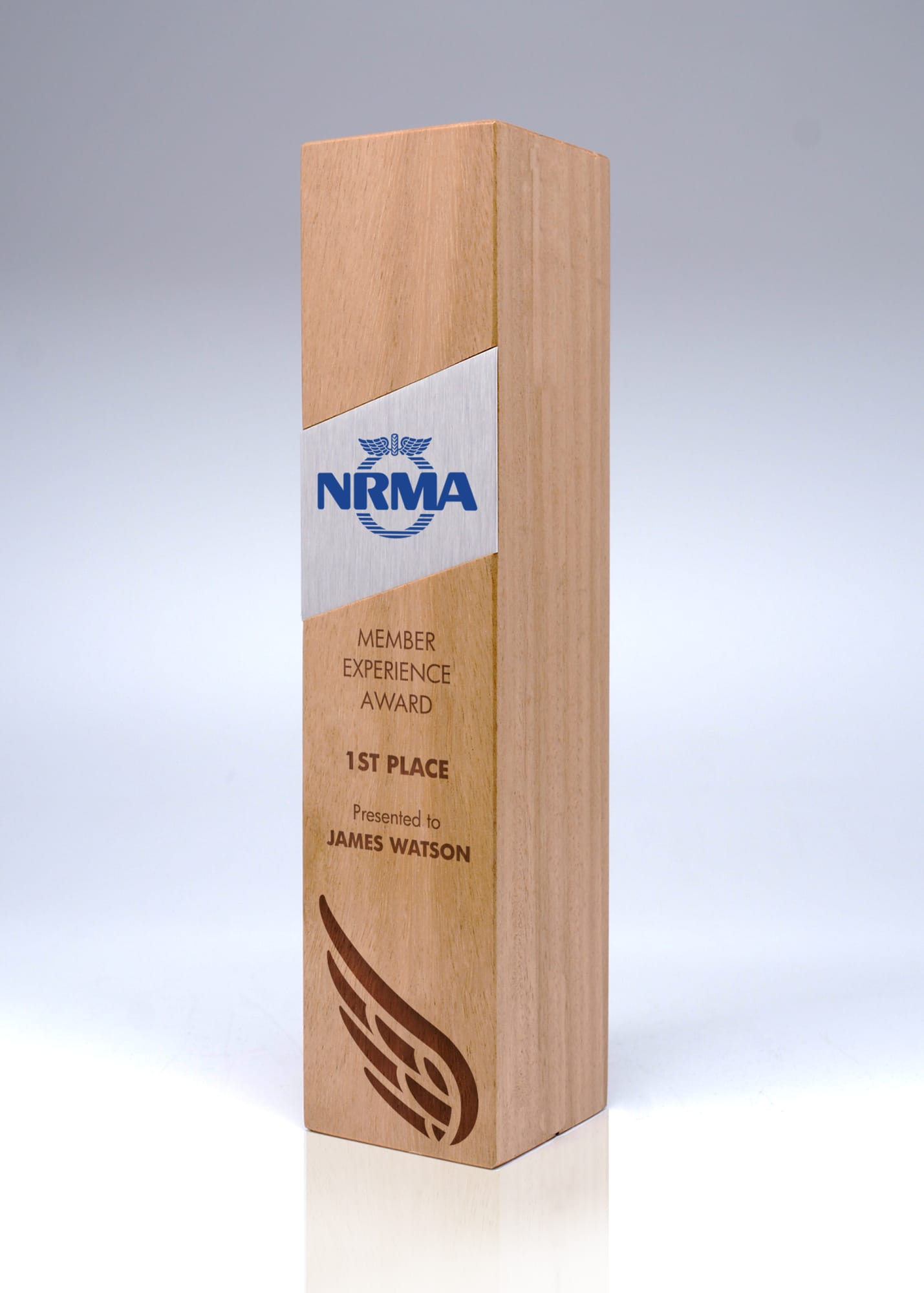 A wooden trophy in light brown, featuring a sleek design and a logo. It has a rectangular shape and a polished finish. Australian Select Grade Blackbutt Trophy - Image 1