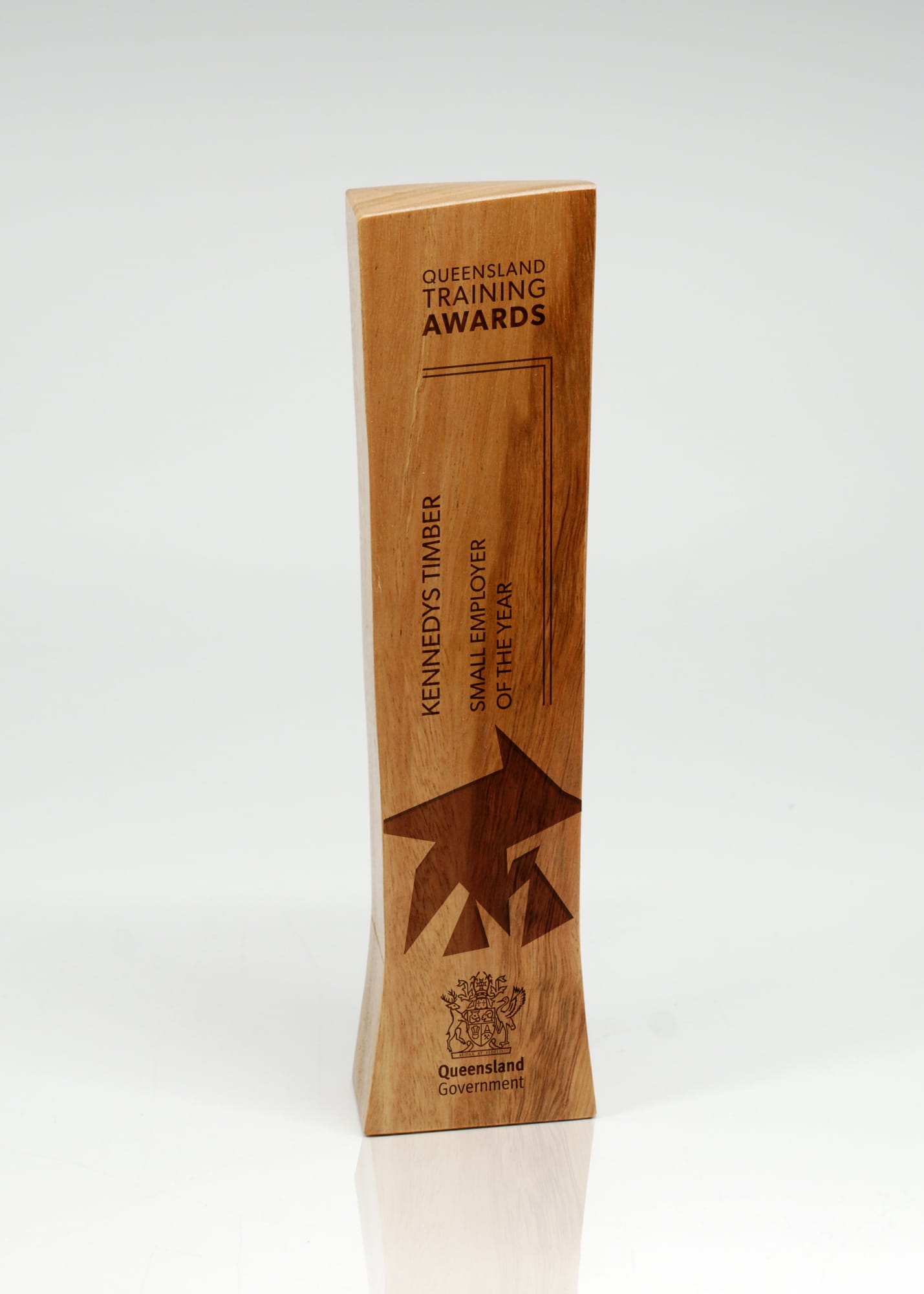 A trophy made of light brown timber with a sleek, modern design and a logo. Australian Select Grade Blackbutt Baton Trophy - Image 1