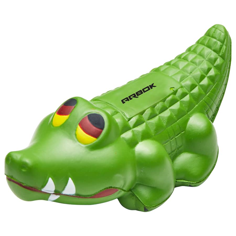 A green crocodile-shaped stress toy with textured skin and distinctive eyes. Features a logo on the side. Squeeze Crocodile - Image 1