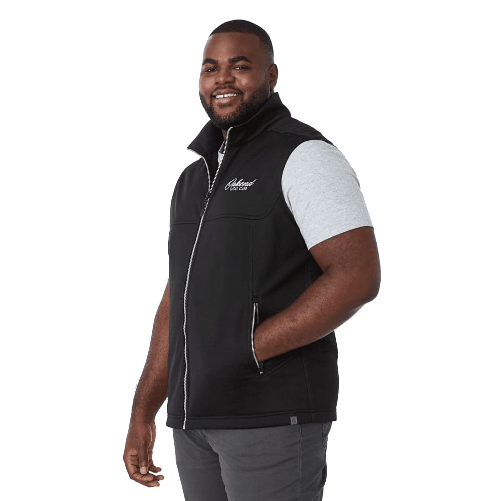 A black eco waterproof softshell vest with a zip front, featuring a logo, worn by a smiling man. Men's Joris Eco Waterproof Softshell Vest - Image 1
