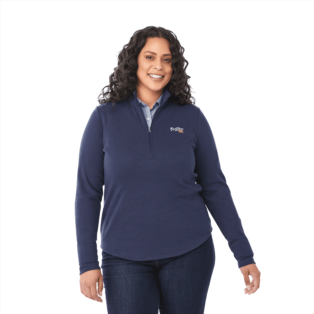 A navy quarter zip jacket for women featuring a logo, paired with a collared shirt and denim. Rigi Eco Knit Quarter Zip - Womens - Image 1