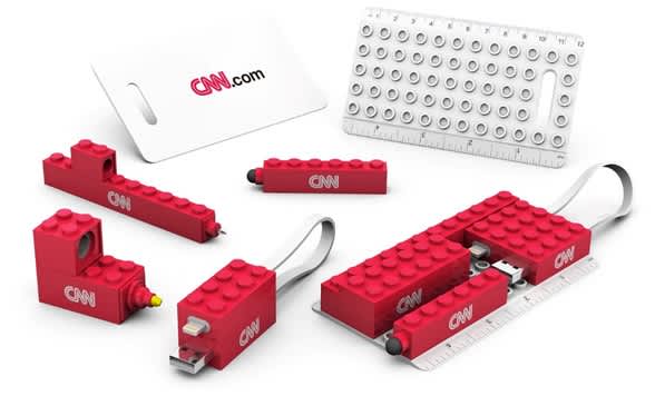 A red travel set featuring various USB sticks, a ruler, and a card, all with a logo. Work From Home Set - Image 1