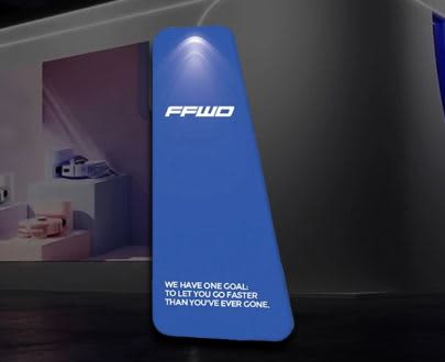 A blue triangular display frame featuring a logo and a light at the top, set against a modern background. Stretch Fabric Display / Tension Fabric Display -Triangular Frame - Image 1